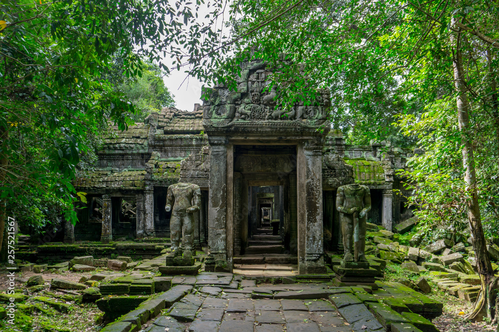 Statues stand guard before the entrance to a temple at the Angkor archeological park