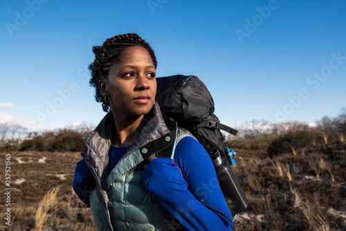 Backpacker standing outdoors and looking away photo