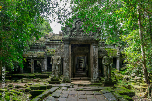 Statues stand guard before the entrance to a temple at the Angkor archeological park