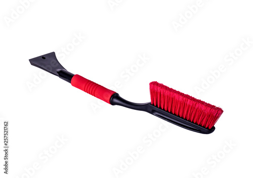 Car accessories for winter - plastic ice scrapers, red telescopic snow brushes with long handle on white background