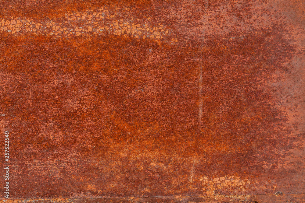 Rusty yellow-red textured metal surface. The texture of the metal sheet is prone to oxidation and corrosion. Textured background in grunge Style Rusty yellow-red textured metal surface. The texture of the metal sheet is prone to oxidation and corrosion. Textured background in grunge Style