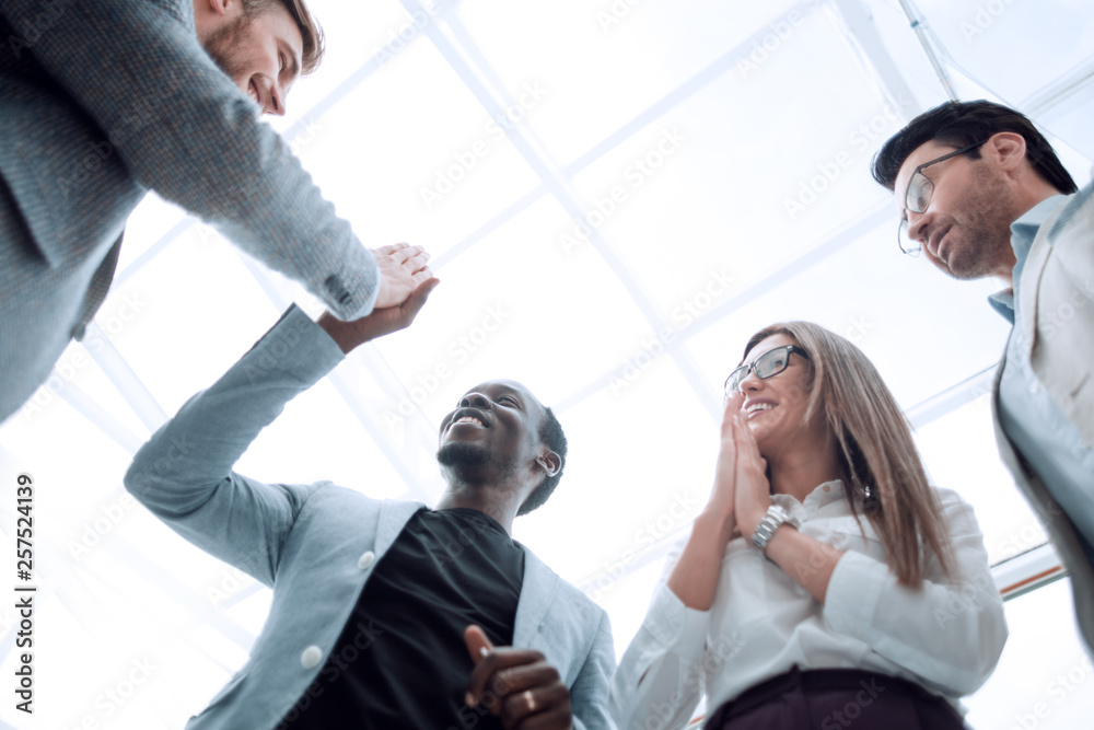 bottom view.happy employees giving each other a high five. bottom view.happy employees giving each other a high five.