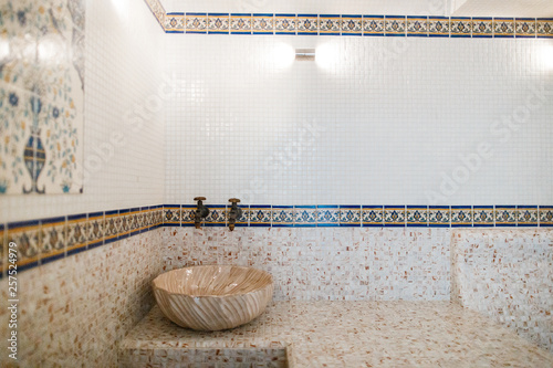 Interior of Turkish sauna, classic Turkish hammam at spa center. Steam room at spa, relaxation and resort health care center interior. Decorated in golden colors. Eastern hammam.