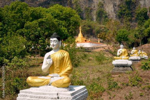 Row of Buddha statues in Garden of One Thousand Buddhas or Lumbini Garden in Hpa-An, Myanmar. photo