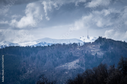 Mountain Dobratsch with radio antenna on snowy summit in spring