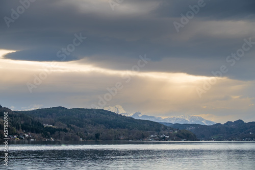 Fototapeta Naklejka Na Ścianę i Meble -  Village Sekim on lake Wörthersee and mountain Mittagskogel, Julian Alps