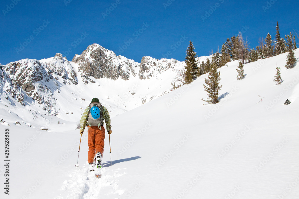 A backcountry skier skins in the Beehive Basin near Big Sky, Montana. A backcountry skier skins in the Beehive Basin near Big Sky, Montana.