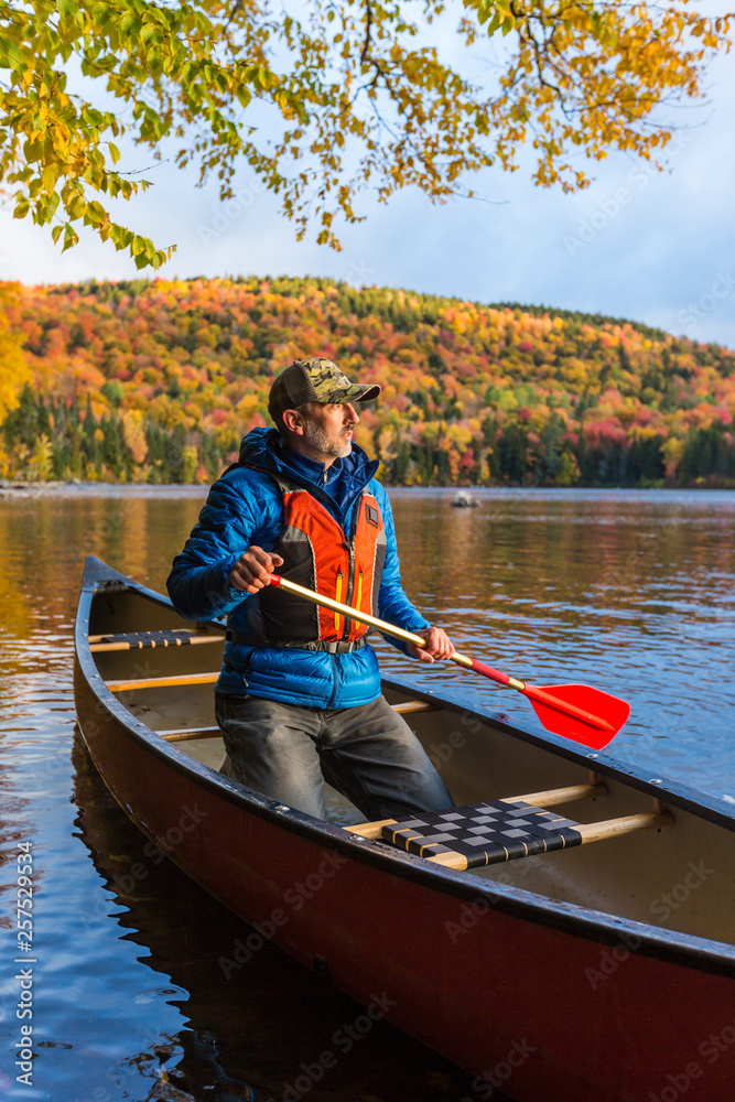 A man canoeing on Greenough Pond, USA A man canoeing on Greenough Pond, USA