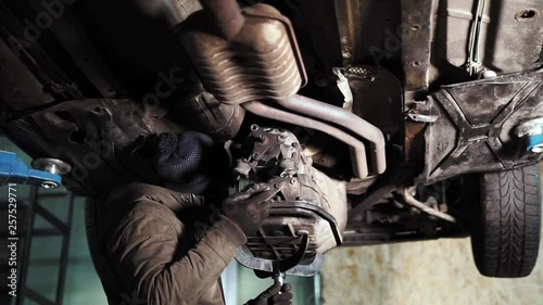 Tilt shot of mechanic attaching the gearbox to the engine