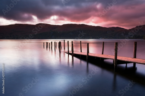 A view across a lake at dawn in the lake district cumbria england