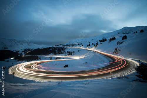 Long exposure of winter traffic on Colorado Highway 6 traveling over Loveland pass at night.