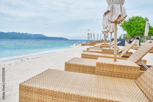 Fototapeta Naklejka Na Ścianę i Meble -  Sun beds with umbrellas on the Bali beach
