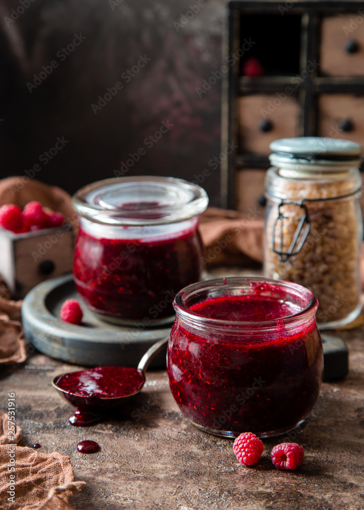 Two glass jars with homemade dark red jam Two glass jars with homemade dark red jam