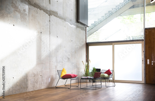 Sitting area in a loft at concrete wall photo