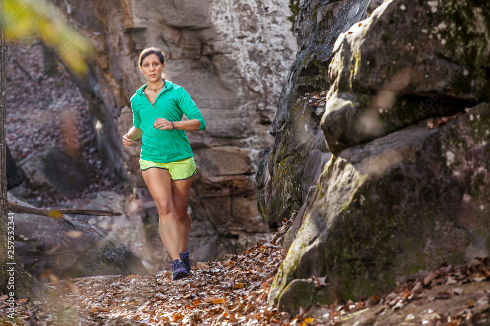 Woman trail running at Moss Rock Preserve in Hoover, Alabama, USA Woman trail running at Moss Rock Preserve in Hoover, Alabama, USA