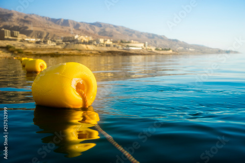 Yellow buoy floating on Dead Sea, Madaba Governorate, Jordan photo