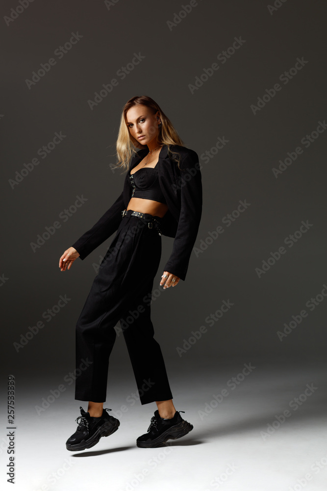 Young beautiful female dancer is posing in the studio Young beautiful female dancer is posing in the studio