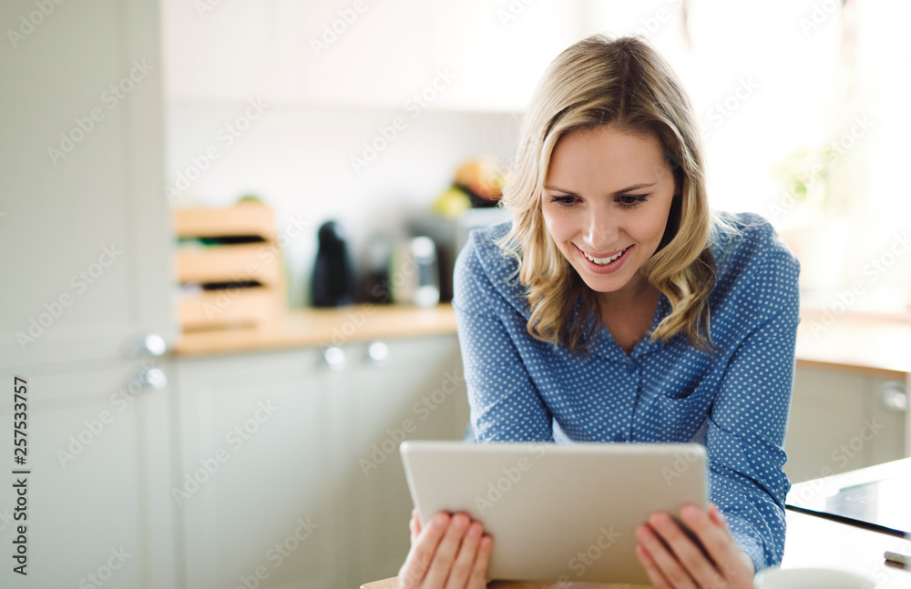Smiling woman using tablet at home Smiling woman using tablet at home