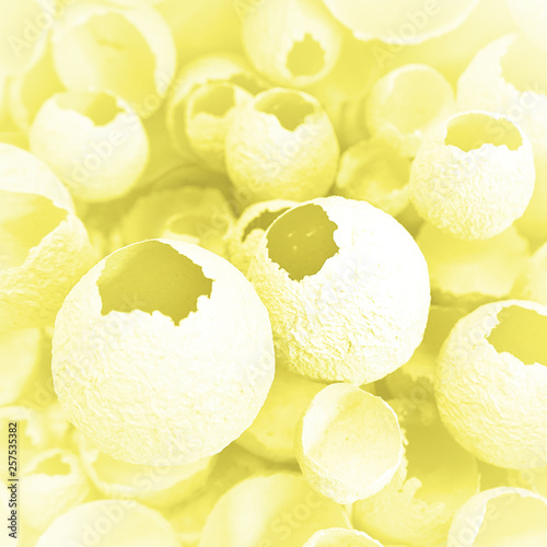 Cracked eggs pattern as gray and yellow background. Top view, flat lay, selective focus. Easter creative minimal concept. Eggshell texture for art background. photo