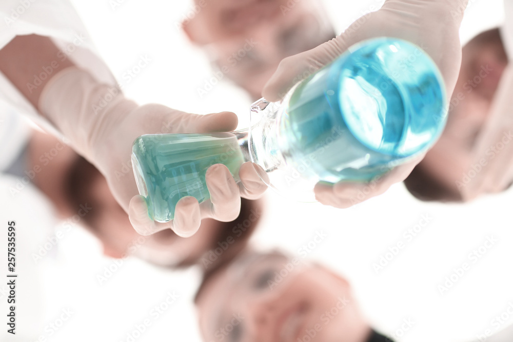 image is blurred. beakers in hand, and scientists image is blurred. beakers in hand, and scientists