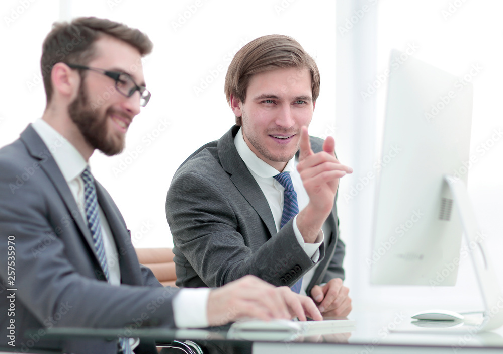 colleagues are discussing new data, sitting at a Desk colleagues are discussing new data, sitting at a Desk