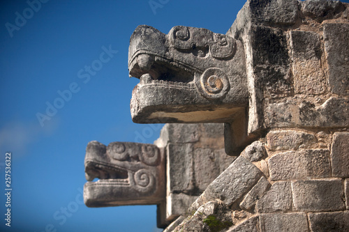 Two heads representing Kukulkan, the Feathered Serpent god, decorate a building in the Mayan city of Chichen Itza, Yucatan Peninsula, Mexico photo