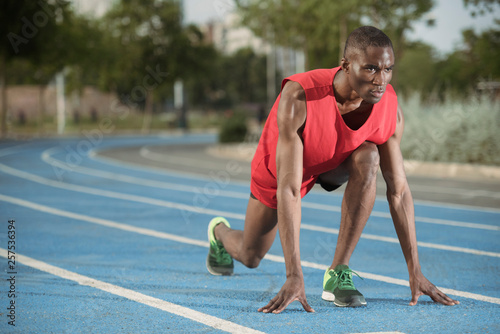 Male athlete preparing to run