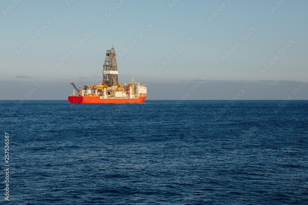 offshore oil and gas drillship, blue ocean background offshore oil and gas drillship, blue ocean background