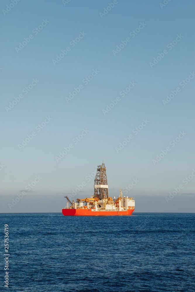 offshore oil and gas drillship, blue ocean background offshore oil and gas drillship, blue ocean background