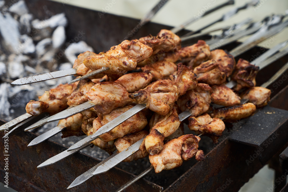 Roasted chicken wings meat kebab on skewers, close-up
