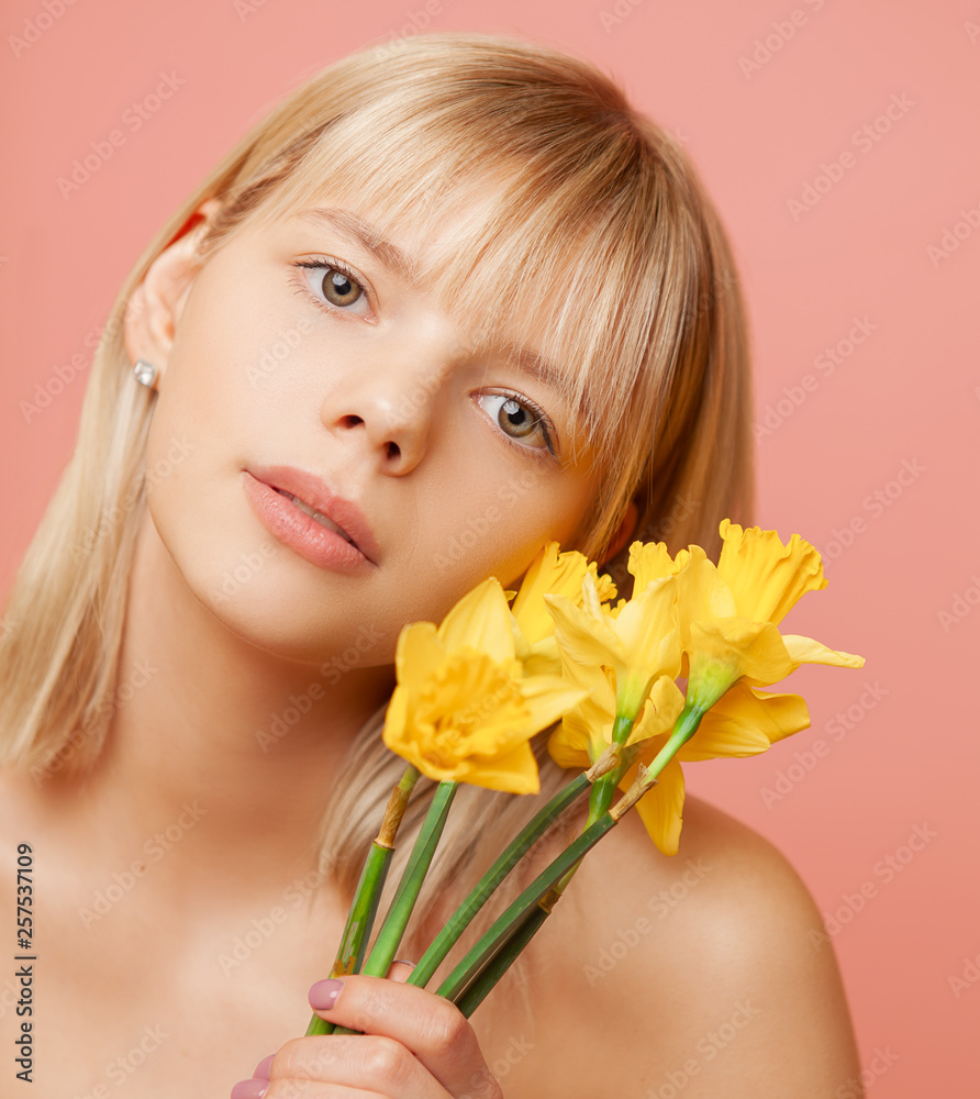 Young woman with fresh healthy skin and hairs holding narcissus and smiling. Cosmetology, beauty and spa Young woman with fresh healthy skin and hairs holding narcissus and smiling. Cosmetology, beauty and spa