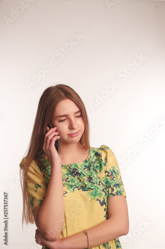 The portrait of an young blonde lady isolated over a white background