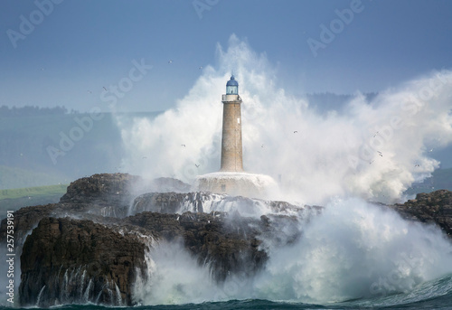 Waves crashing around lighthouse, Santander, Cantabria, Spain photo