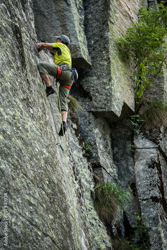 Man trad climbing a crack route in Esigo, Ossola, Italy. Ossola is one of the main destination in Europe for crack climbing. photo