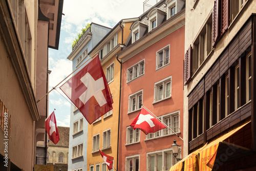 Picturesque old town street with Swiss flags, Zurich, Switzerland photo