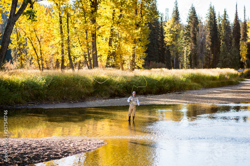 Man fishing in river on sunny day