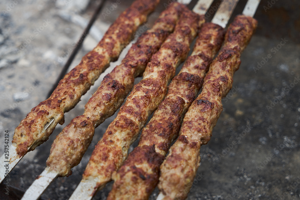 Shish kebab on a metal stick, top view. Lula kebab on skewers 