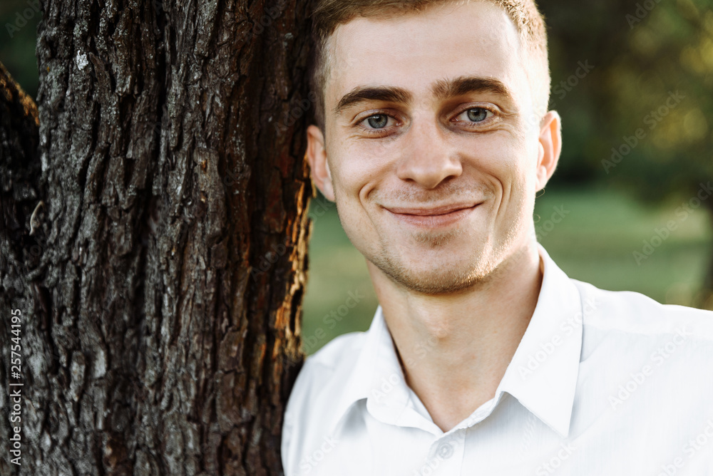 Close-up portrait of handsome guy with blue eyes and cute smile