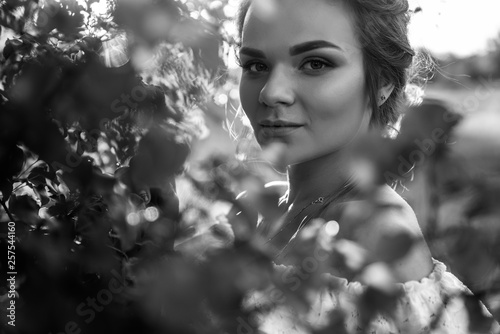 Beautiful black and white portrait of an amazing cute girl, outdoors. Close-up