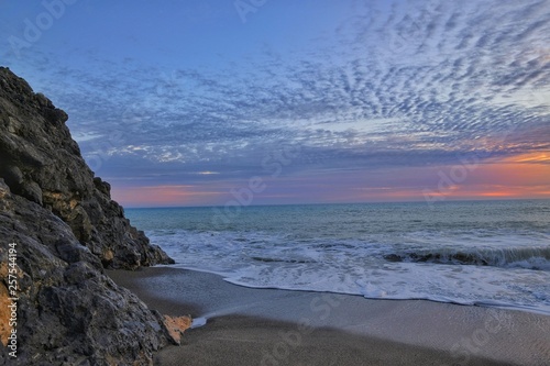 wide angle sunset on south italian sea coast,wave splashing on sandy beach © paolo