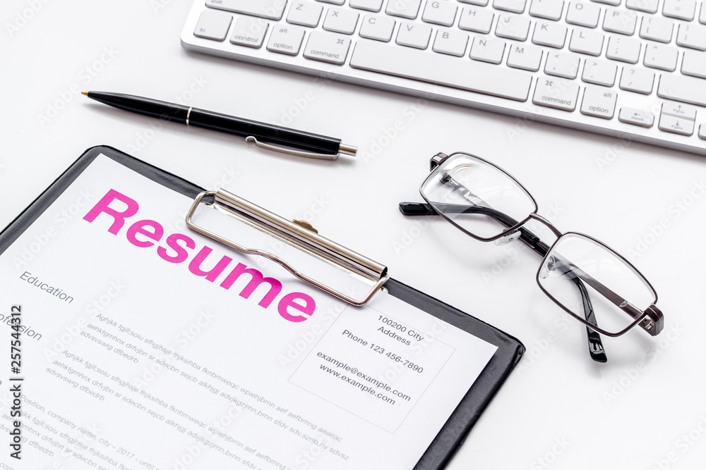 Create CV concept with pen, glasses, keyboard on white desk top view Create CV concept with pen, glasses, keyboard on white desk top view