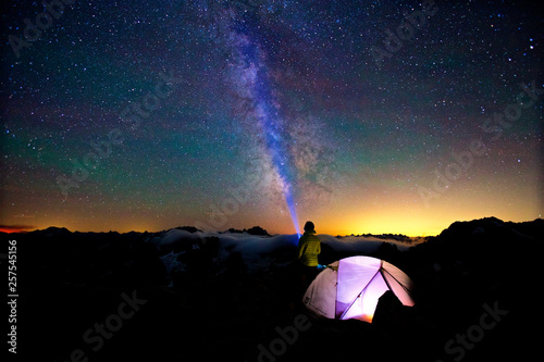 Starry sky with Milky way over illuminated tend
