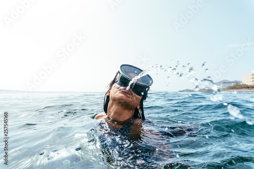 Woman in diving goggles spitting out water, Tenerife, Canary Islands, Spain photo