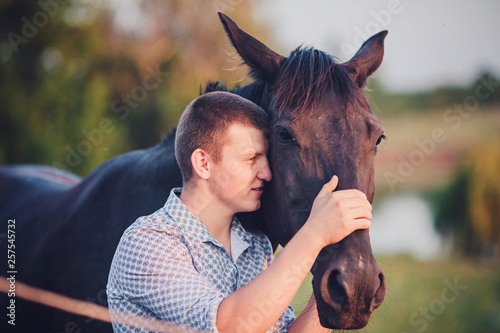young man and a horse photo