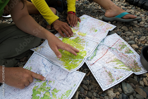 Two women check the maps to plan logistics as they navigate the Onon river in northern Mongolia. photo