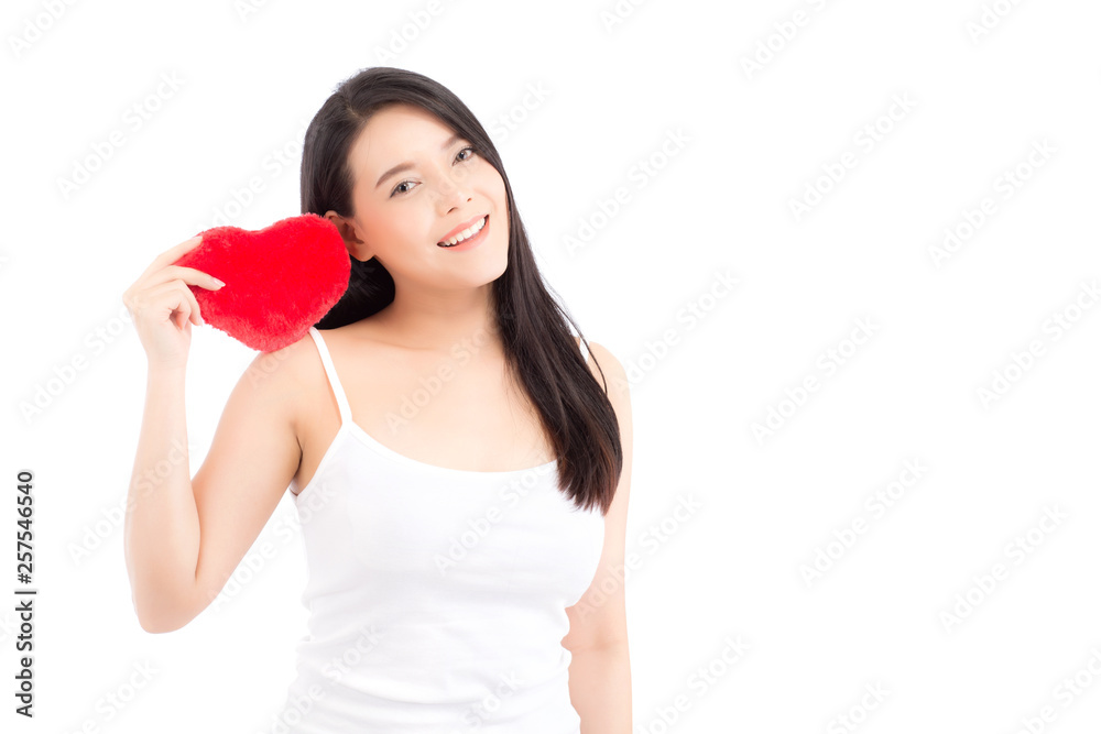 Portrait of beautiful asian young woman holding red heart shape pillow and smile isolated on white background, valentines day, holiday concept. Portrait of beautiful asian young woman holding red heart shape pillow and smile isolated on white background, valentines day, holiday concept.