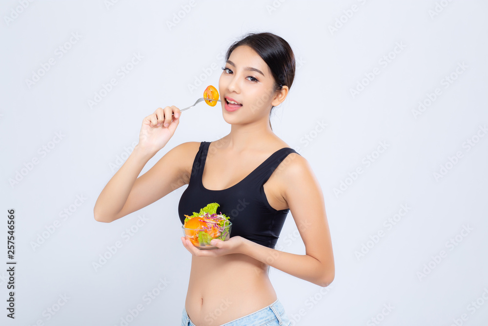 Beautiful portrait young asian woman smiling holding salad vegetable food isolated on white background, girl diet eating vegetarian for healthy, health care or wellness concept. Beautiful portrait young asian woman smiling holding salad vegetable food isolated on white background, girl diet eating vegetarian for healthy, health care or wellness concept.