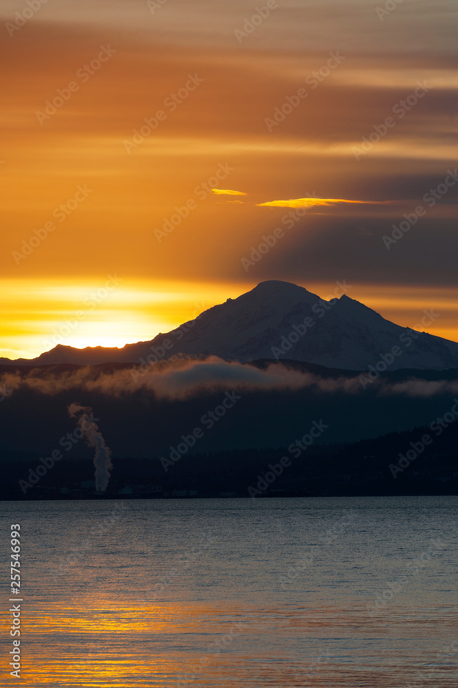 Sunrise Over the Active Volcano, Mt. Baker, in the North Cascade Mountain Range. Mt. Baker is one of the snowiest places in the world and is located 31 miles east of Bellingham, Washington.