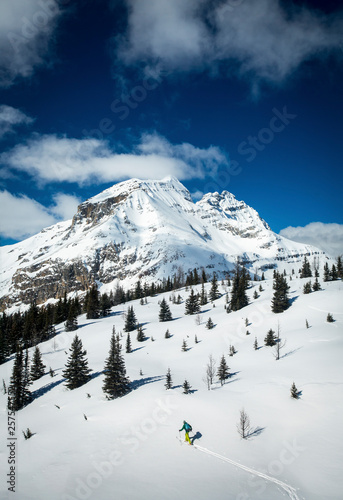 Snow covered mountain and hiker in winter, Lake O'Hara, Yoho National Park, Alberta, Canada photo