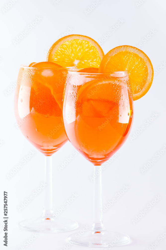 Cocktail aperol spritz on white background. Summer alcoholic cocktail with orange slices. Italian cocktail aperol spritz on white. Isolated Cocktail aperol spritz on white background. Summer alcoholic cocktail with orange slices. Italian cocktail aperol spritz on white. Isolated